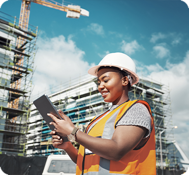Woman at a construction site looking at a clipboard
